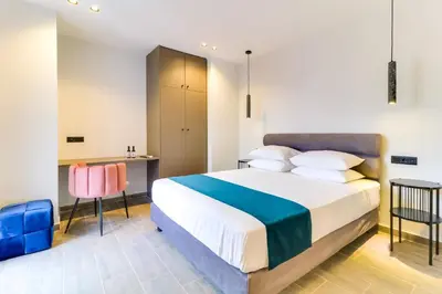 a bedroom with a large bed and a desk at ABOV Athens in Athens