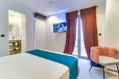 a bedroom with a bed and a chair and a window at ABOV Athens in Athens