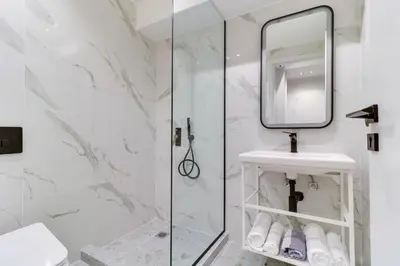 a bathroom with a shower and a sink and a mirror at ABOV Athens in Athens