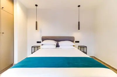 a bedroom with a large bed with two pillows at ABOV Athens in Athens