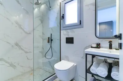 a bathroom with a shower and a toilet and a sink at ABOV Athens in Athens