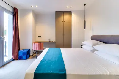 a bedroom with a large bed and a desk at ABOV Athens in Athens