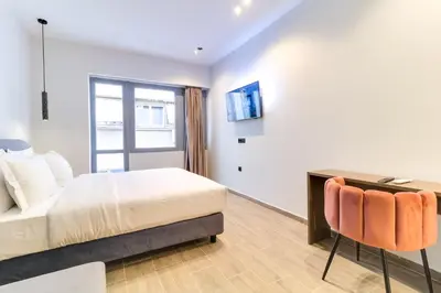 a bedroom with a bed and a desk and a chair at ABOV Athens in Athens