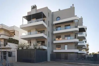 a building with balconies on the side of it at Glyfada Experience Residence in Athens