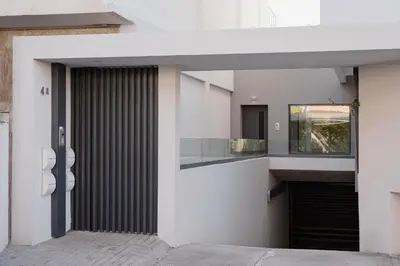 an external view of a white building with a door at Glyfada Experience Residence in Athens