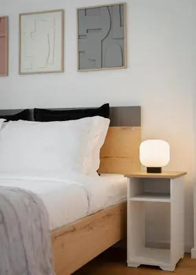 a bedroom with a bed and a table with a lamp at Glyfada Experience Residence in Athens