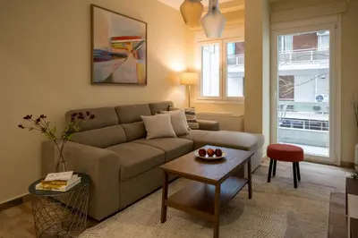 a living room with a couch and a table at Mia Homes - National Museum in Athens