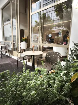 a patio with tables and chairs in a building at Eternity Athens in Athens