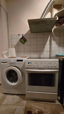 a kitchen with a stove and a washing machine at ATHENS O'GERA escape in Athens