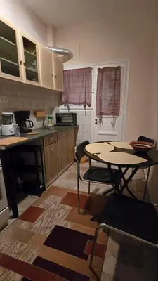 a kitchen with a table and a table and chairs at ATHENS O'GERA escape in Athens