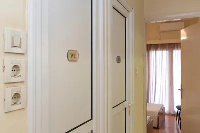 a room with a door with a mirror and a bedroom at Piraeus Pasalimani X6 near metro in Piraeus