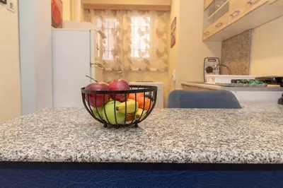 a bowl of fruit on a counter in a kitchen at Piraeus Pasalimani X6 near metro in Piraeus