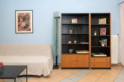 a room with a bed and a wooden book shelf at Piraeus Pasalimani X6 near metro in Piraeus