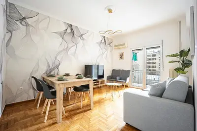 a living room with a table and a couch at GK Agorakritou in Athens