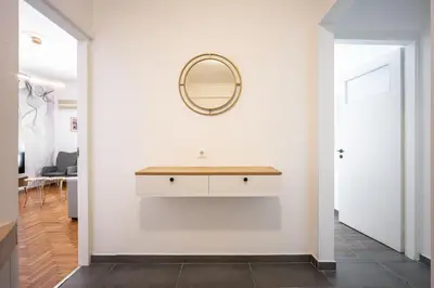 a white hallway with a vanity and a mirror on a wall at GK Agorakritou in Athens
