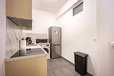 a small kitchen with a refrigerator and a stove at GK Agorakritou in Athens