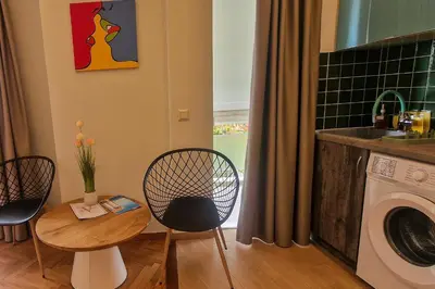 a kitchen with a table and chairs and a washing machine at New Luxury Studio, Near Hilton, Central , Ventiri Suite 7 in Athens