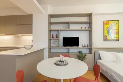a living room with a white table and a white couch at Perfect Spot! Studio in Kolonaki in Athens