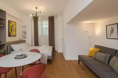 a living room with a couch and a table at Perfect Spot! Studio in Kolonaki in Athens