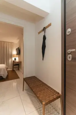 a room with a bench and an umbrella hanging on the wall at Prime Location Kolonaki Burrow in Athens