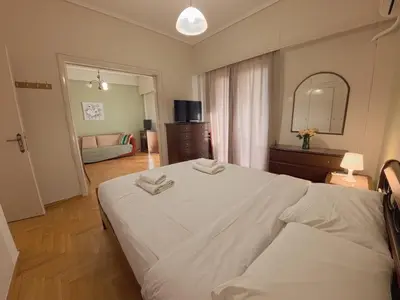 a bedroom with a large bed with two towels on it at Urban 16 in Athens
