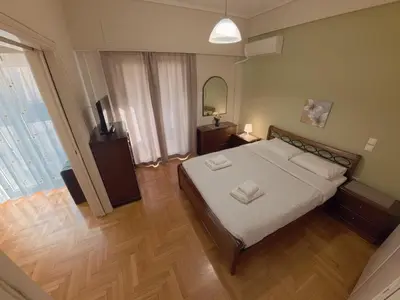 a bedroom with a bed with white sheets and a mirror at Urban 16 in Athens