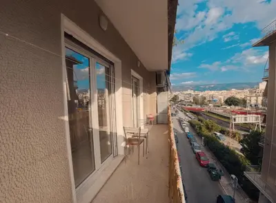 a balcony with chairs and a view of a city at Urban 16 in Athens