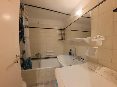 a bathroom with a tub and a sink and a mirror at Urban 16 in Athens