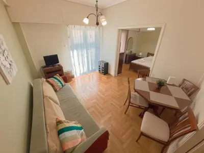 a living room with a couch and a table at Urban 16 in Athens