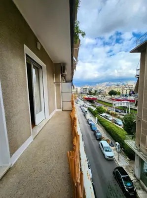 a balcony of a building with cars parked on the street at Urban 16 in Athens