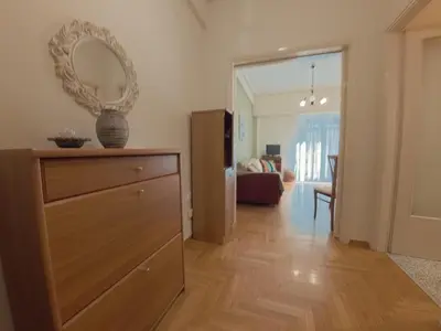 a living room with a dresser and a mirror at Urban 16 in Athens