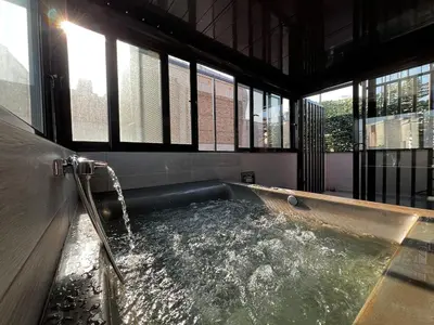 a hot tub with water in a room with windows at Private hottub Athens Skythens omonoia in Athens