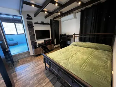a bedroom with a bed and a television in it at Private hottub Athens Skythens omonoia in Athens