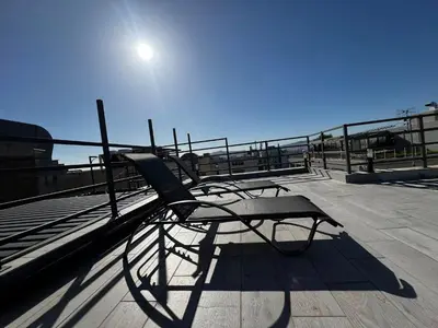 a bench on a pier with the sun in the sky at Private hottub Athens Skythens omonoia in Athens