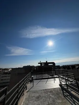 a view from the roof of a building with the moon in the sky at Private hottub Athens Skythens omonoia in Athens