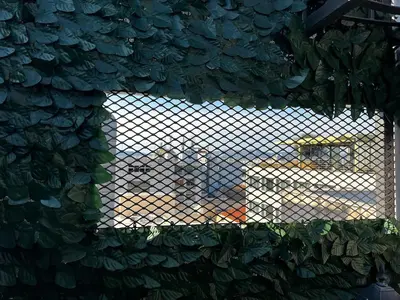 a view of a train through a chain link fence at Private hottub Athens Skythens omonoia in Athens