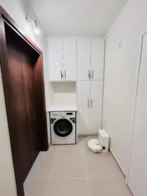 a small bathroom with a washing machine and a toilet at T seaside cozy APT in Athens