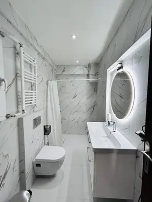 a bathroom with a toilet and a sink and a mirror at T seaside cozy APT in Athens