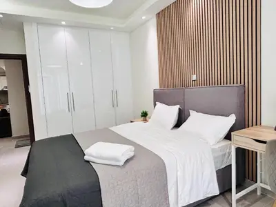 a bedroom with a bed with white pillows on it at T seaside cozy APT in Athens