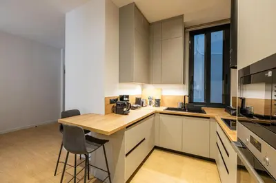 a kitchen with white cabinets and a wooden counter top at Rooms151 Business Suite in the Heart of Athens 2nd floor-5 in Athens