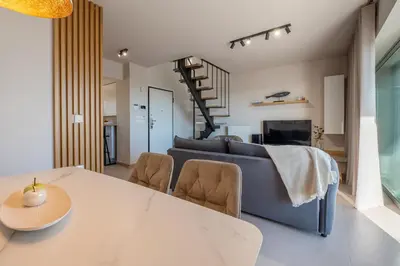 a living room with a couch and a table at Elite Penthouse with Heated Pool and SkylineView in Piraeus