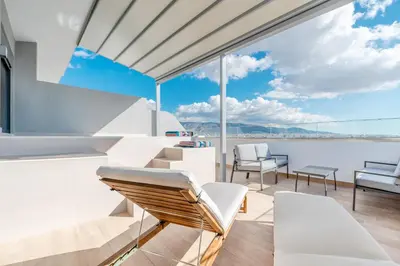 a balcony on a yacht with views of the water at Elite Penthouse with Heated Pool and SkylineView in Piraeus