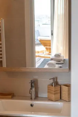 a bathroom with a sink and a mirror at Elite Penthouse with Heated Pool and SkylineView in Piraeus