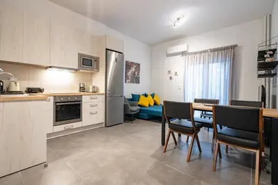a kitchen and dining room with a table and chairs at Evaggelismos Apt Metro Station 1 bdrm 2pers by MPS in Athens