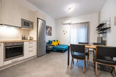 a kitchen and dining room with a table and chairs at Evaggelismos Apt Metro Station 1 bdrm 2pers by MPS in Athens
