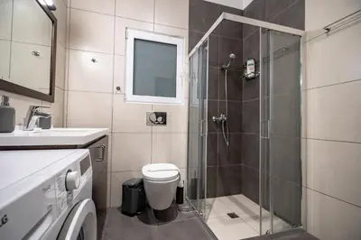 a bathroom with a shower and a toilet and a sink at Evaggelismos Apt Metro Station 1 bdrm 2pers by MPS in Athens
