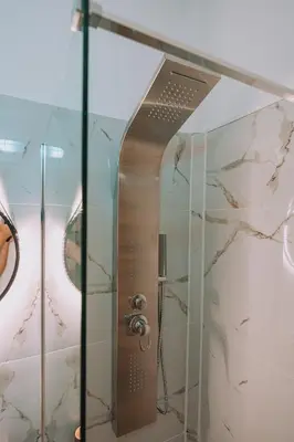 a shower with a glass door in a bathroom at 4BED Apartment in the heart of Athens in Athens
