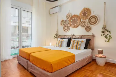 a bedroom with a bed and a large window at 4BED Apartment in the heart of Athens in Athens