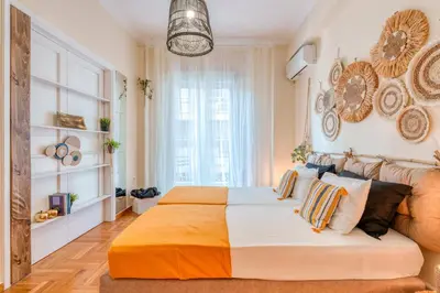 a bedroom with a large bed and a couch at 4BED Apartment in the heart of Athens in Athens