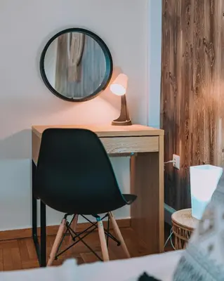 a desk with a chair and a mirror on it at 4BED Apartment in the heart of Athens in Athens